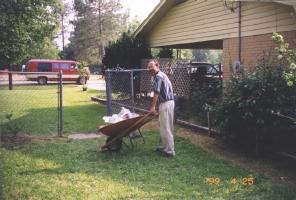 Paul learning how to use a wheelbarrow